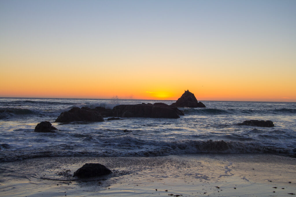 Waves crash along rocks near San Simeon, CA